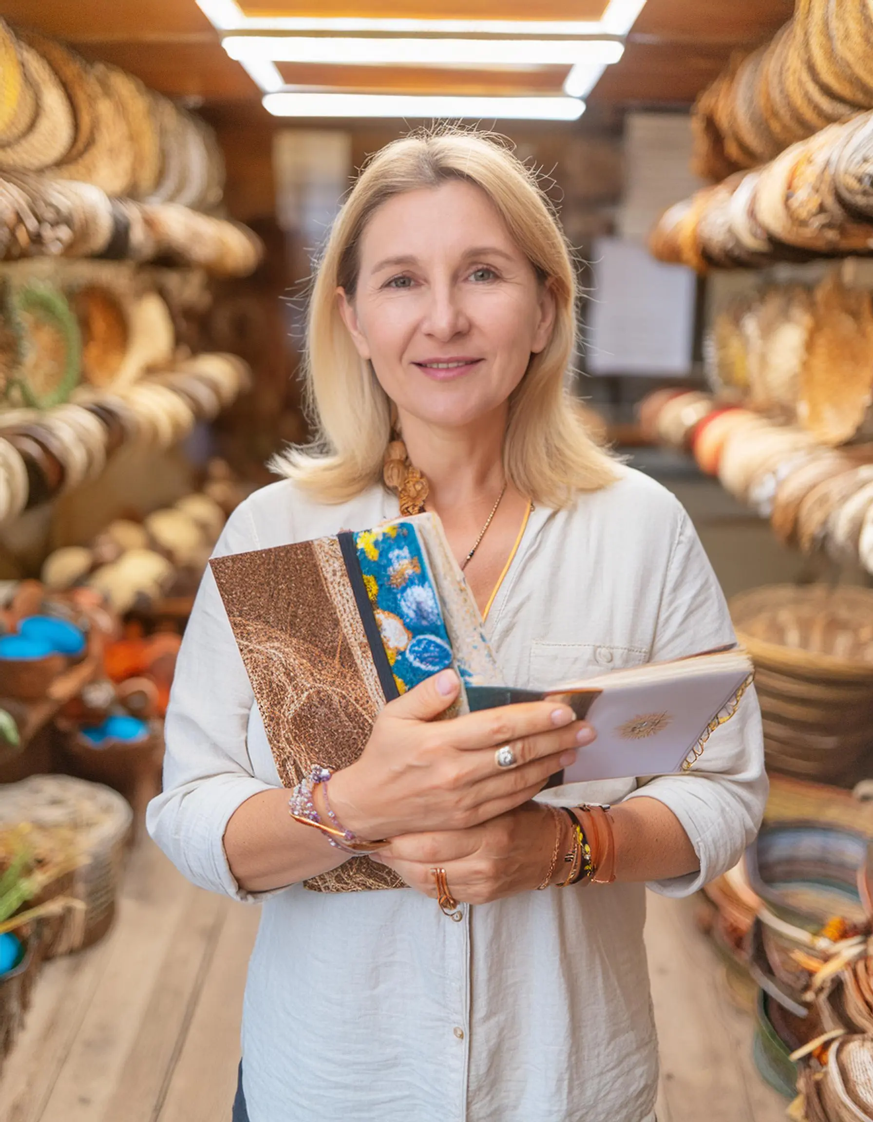tourist focused shop owner holds a guidebook with handmade souvenirs