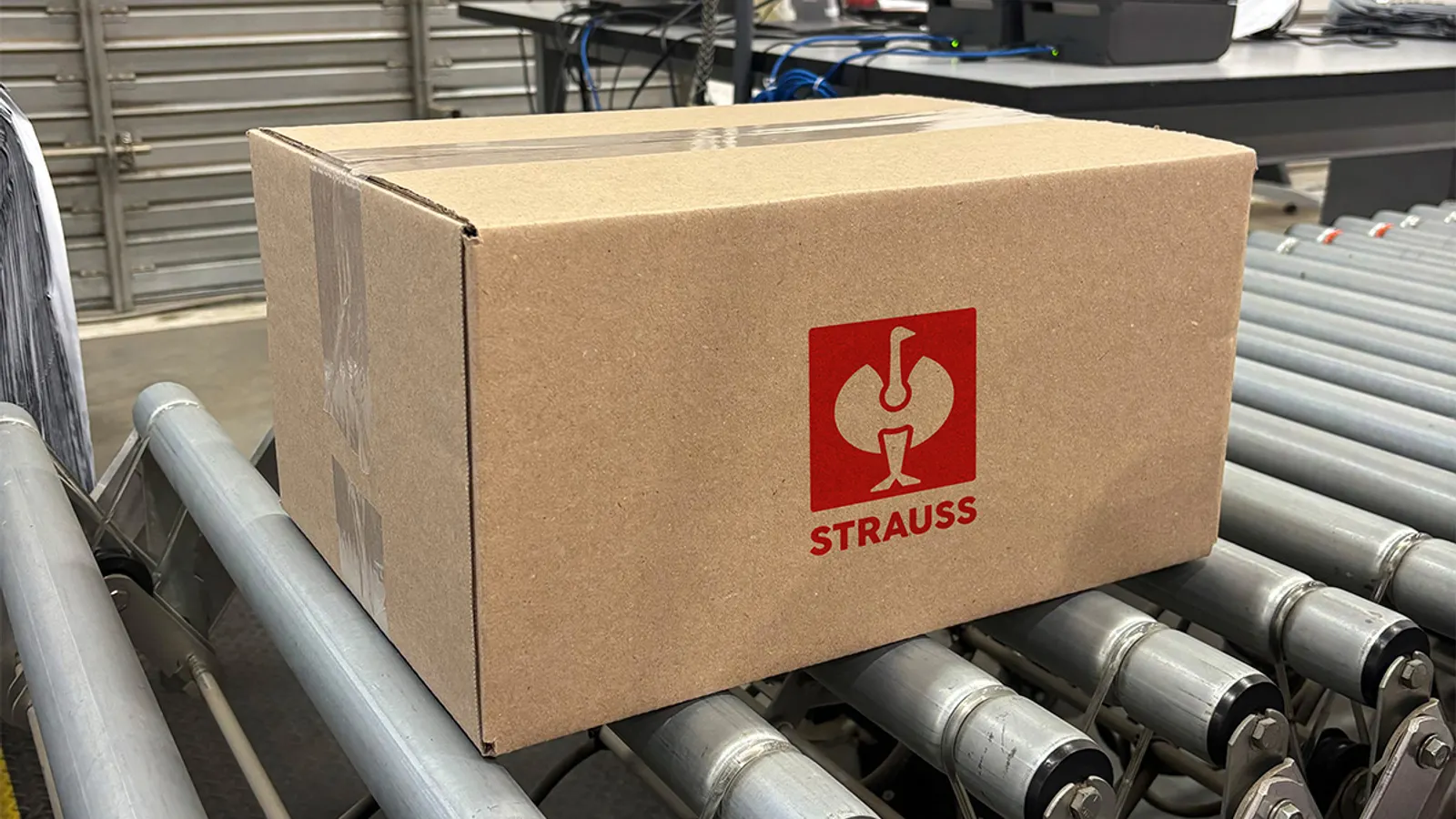 Warehouse workers managing an end-to-end logistics deal for workwear distribution