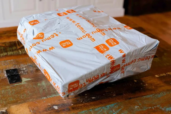 Warehouse workers sorting packages for local fulfillment logistics amid de minimis rule changes